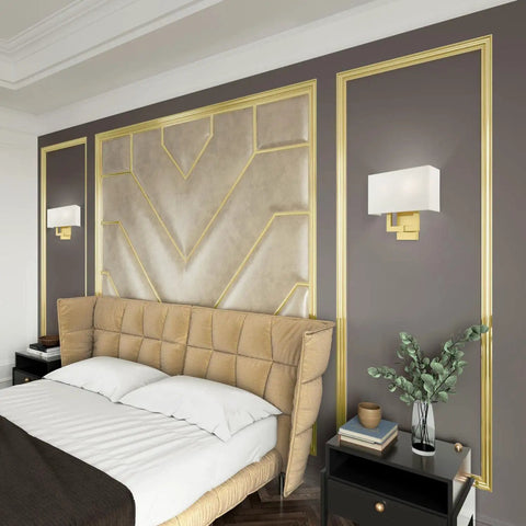 Two Light Wall Sconce In Satin Brass With Dope Off White Hardback Fabric Shade For A Clean Modern Vibe ADA Compliant Meridian Collection Contemporary Home Lighting 13 By 12.5 Inches in a bedroom setting