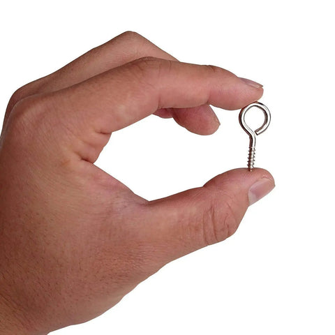 Hand holding a 1-inch nickel-plated screw eye from the One Inch Screw Eye And Eye Hook Set Nickel Plated For Lightweight DIY Projects.