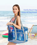 Woman holding Big Mesh Beach Bag For Fam Trips Fits Four To Six Towels Water Bottles Sunscreen And Gear Nine Pockets For Anti Chaos Organization Ideal For Beach Pool Cruise And Summer Fun.