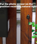 Photo Eye Light Sensor For Power Pack Transformers, Dusk To Dawn Auto On Off Switch installed on a wooden surface outdoors.
