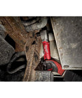M12 Fuel Half Inch Right Angle Impact Wrench Kit used in tight space under vehicle, showing compact design and Powerstate motor