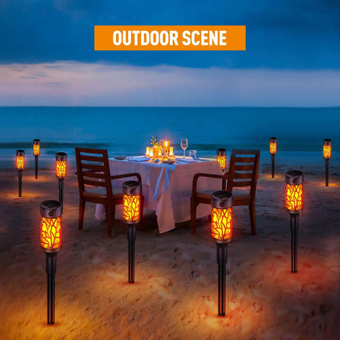 12 Pack Solar Outdoor Lights Extra Bright Solar Torch Lights With Dancing Flickering Flames Lit for beachside dining scene