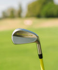 ButterBlade Training Club For Golfers close-up on green field, stainless head with stiff shaft for swing mechanics improvement