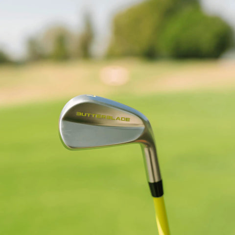 ButterBlade Training Club For Golfers close-up on green field, stainless head with stiff shaft for swing mechanics improvement