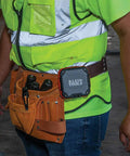 Rugged Bluetooth Speaker With Magnetic Strip And Hook attached to worker's belt at construction site, hands-free use.