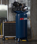 Heavy Duty Sixty Gallon Two Stage Air Compressor with cast iron pump in garage setting next to tool cart.