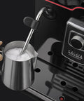 Accademia Luxury Italian Fully Automatic Espresso Machine With 19 On Demand Beverages Massive Customization Glass Touchscreen Commercial Steam Wand Brushed Stainless Steel Build Made In Italy with steam wand in use.