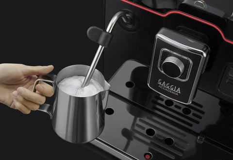Accademia Luxury Italian Fully Automatic Espresso Machine With 19 On Demand Beverages Massive Customization Glass Touchscreen Commercial Steam Wand Brushed Stainless Steel Build Made In Italy with steam wand in use.
