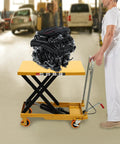 Heavy Duty 500 Lbs Hydraulic Lift Cart With Single Scissor Table Top Lifter And Universal Wheels Plus Rack For Freestanding Workshop Garage Material Handling carrying an engine in a workshop.