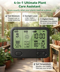 Wireless Soil Moisture Meter With LCD Receiver Pro Grade 3 Probe 3 In 1 Sensor For Moisture Temperature And Light Expandable To 12 Zones 230 Ft RF Range Waterproof Long Battery Life For Indoor Outdoor Plants And Gardens displaying on a table with surrounding plants in a greenhouse setting.