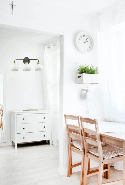 White room with black finish Three Light Bathroom Vanity Light With White Shade In Black Finish Wall Mount Vanity Fixture For Over Mirror Modern Bath Lighting For Clear Bright Illumination installed over a mirror.