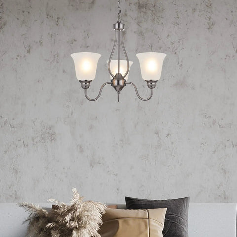 Lit Three Light Chandelier In Brushed Nickel With Frosted Glass Shades above sofa, elegant room setting