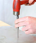 Person using 11 Piece Punch And Chisel Set For Metalworking Pro Grade Tools Made From Heat Treated Alloy Steel on metal surface