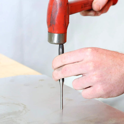 Person using 11 Piece Punch And Chisel Set For Metalworking Pro Grade Tools Made From Heat Treated Alloy Steel on metal surface