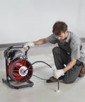 Heavy Duty Drain Cleaning Machine With 75 Ft Sewer Snake And 3/8 Inch Steel Core Auger in use, tackling drain clogs.