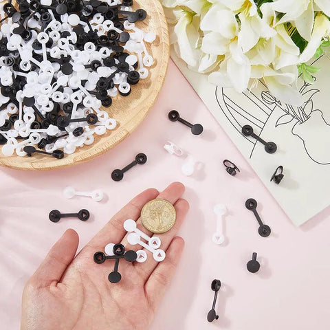 Secure Your Gear Hella Smooth With 300 Black White Tag Fasteners Plastic Flat Round Security Ties Anti Theft Snap Locks in hand.