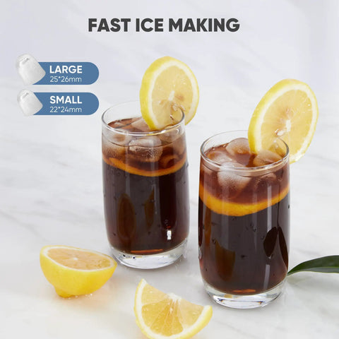 Two drinks with bullet ice cubes and lemon slices, next to a lemon wedge, showcasing Countertop Ice Maker With Sturdy Carry Handle, Portable Ice Machine Freezing Bullet Ice Cubes In Rapid Six Minutes, Delivers Twenty Six Pounds Daily, Lowkey Essential Home And Tailgate Chiller In Jet Black.