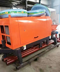 Heavy Duty Concrete Transfer Pump For Construction Sites Built Tough To Move Slurry Fast With Gate Valve, Delivery Equipment, And Custom Pipeline Extensions For Logistics Parks And Warehouse Projects Pro Grade. orange concrete transfer pump with hoses and steel base in workshop