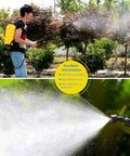 Man using a yellow Five Gallon Garden Sprayer Knapsack With Adjustable Nozzles And Piston Pump For Easy Lawn Care And Pest Control