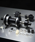 E Bike Hub Motor Axle Kit With 12mm Shaft Front Lock Nut Washer And Protective Cover components on a metal table