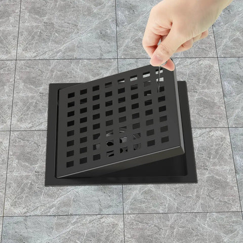 Hand lifting grid cover of 6 Inch Matte Black Shower Drain Square Floor Drain Kit With Flange Stainless Steel Pro Grade Construction