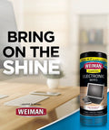 Weiman electronic screen cleaner wipes bottle on desk beside laptop, front view.