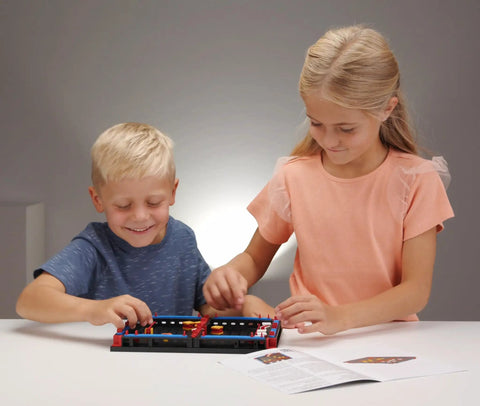 Slide Battle Building Kit With 102 Components For Big Kids And Adults Who Love To Build And Create, Ages 7 And Up, A Smart Expansion For Your Build Your Own Game Set, Perfect For Get Your Game On Competitive Play And Brain Boosting Fun; two kids playing
