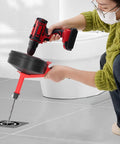 Heavy Duty Manganese Steel Drain Auger And Thirty Two Foot Plumbing Snake For Kitchen Bathroom Pipe Unclogging With Kink Resistant Coating in use with drill.