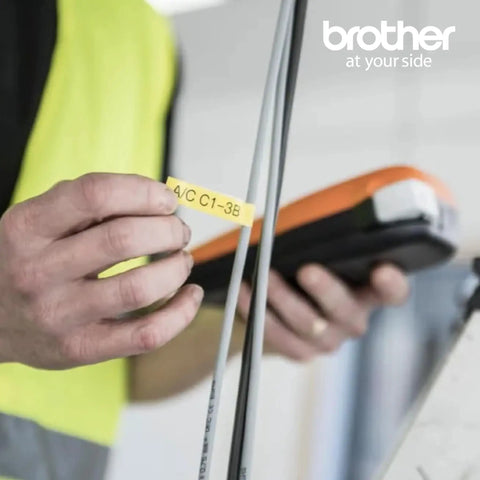 Person using an orange Entry Level Industrial Handheld Labeling Tool Kit For 12mm Labels Orange, Rugged On The Go Label Printer