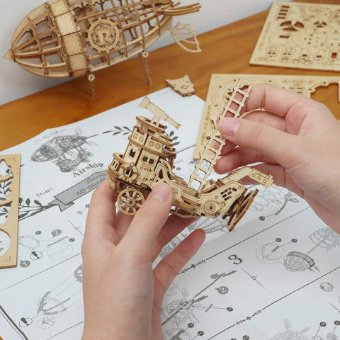 Hands assembling the 3D Wooden Airship Puzzle Kit For Kids And Adults Build Your Own Model Ship In 1 To 2 Hours 176 Laser Cut Pieces