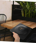 Premium Heavy Duty Adjustable Table Leg Hardware Kit With Beefy Cast Iron Flat Mount Plates held above a wooden table.