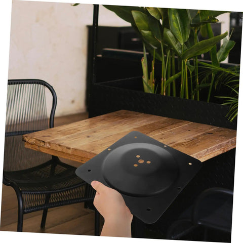 Premium Heavy Duty Adjustable Table Leg Hardware Kit With Beefy Cast Iron Flat Mount Plates held above a wooden table.