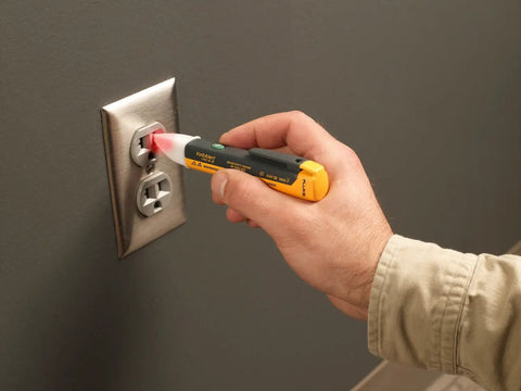 Hand using 1AC II VoltAlert Non Contact Voltage Tester, Pocket Sized, Detects 90 to 1000V AC with Red Tip Glow and Audible Beeper