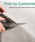 Hands using scissors to trim Extra Thick Non Slip Rug Pad Gripper 2 by 3 Feet Keeps Area Rugs From Sliding On Hardwood Floors