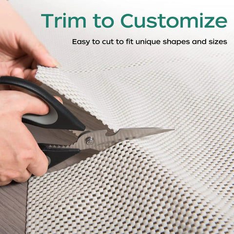 Hands using scissors to trim Extra Thick Non Slip Rug Pad Gripper 2 by 3 Feet Keeps Area Rugs From Sliding On Hardwood Floors