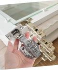 Rock Solid Stainless Steel Concealed Cabinet Hinges With Slick Silent Soft Close Self Closing Design For Kitchen Cupboards featuring a hand holding one hinge.