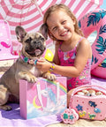 Smiling girl with dog on beach holding Fifty Plus Piece DIY Wristbands And Purse Kit For Girls Create Two Silicone Purses Three Charm Wristbands