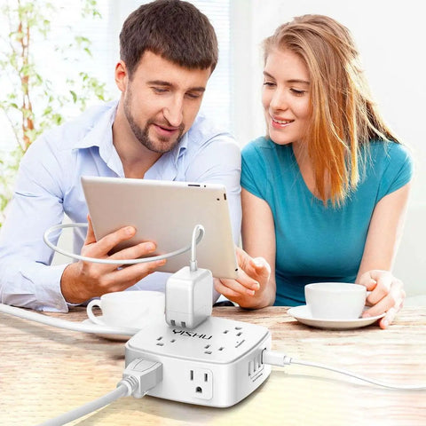 Couple using a tablet with Heavy Duty Surge Protector Power Strip With Six Foot Cord And Eight Wide Outlets Plus Four Fast Charge Usb Ports.