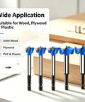 Premium Tungsten Carbide Forstner Drill Bit Set With Quick Fit Hex Shank For Dang Precise Woodworking And Plywood Drilling display of five drill bits on a workbench.