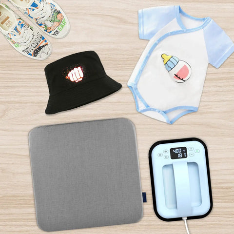 Baby onesie, hat, sneakers, and heat press on table with Light T Shirt Heat Transfer Paper Pack 10 Sheets 8.5x11 for tees.