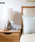 Bedroom scene with USB Wall Outlet With Turbo Fast Charging USB Ports, 15 Amp Tamper Resistant Receptacle near a lamp.