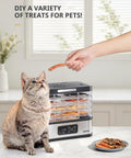 Totally Nifty Compact 5 Tier Food Dehydrator With Bpa Free Trays, drying pet treats with a cat observing in a kitchen.