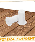 Premium Silicone Antenna Protectors And Wall Hole Plugs For Seamless Drywall Cable Routing. White silicone wall hole plugs on wood surface, not easily deformed.