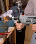 Person using Beefy 7 Amp Hammer Drill Corded 1/2 Inch Chuck 3000 RPM Variable Speed With 10 Drill Bits For Wood Masonry Steel DIY Home Improvement