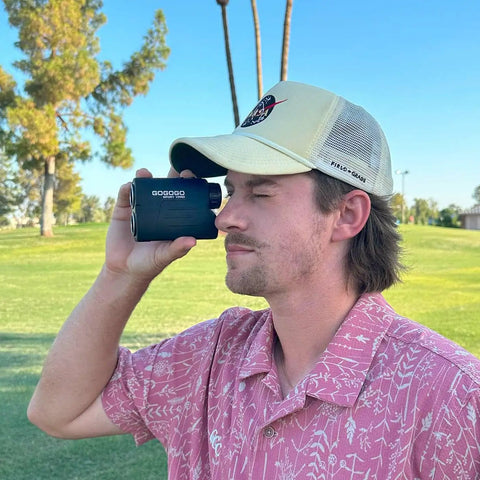 Man using Laser Rangefinder For Golf And Hunting With 6X Magnification And Precision Distances To 1000 To 1200 Yards.
