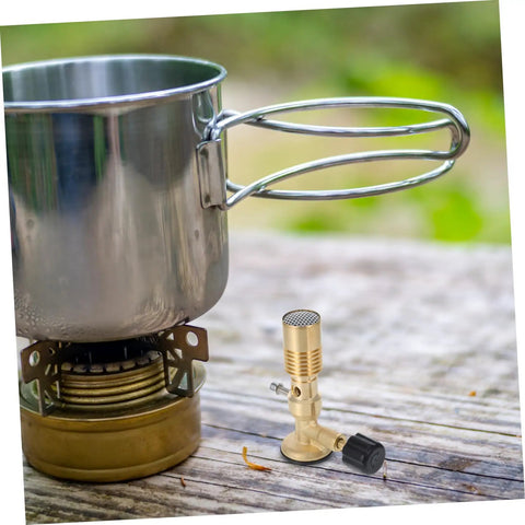 Portable Gas Blowtorch Head For Camping And Outdoor Cooking next to a pot on outdoor table, brass propane burner, adjustable flame.