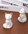 Cute white ceramic cat figurines for bathroom decor, enhancing style in Level Up Your Bathroom Vibe With This Dope Set Of Ceramic Cat Toilet Bolt Covers And Floor Screw Caps Rust Proof Maximalist Accent For Hiding Ugly Base Screws Forever.