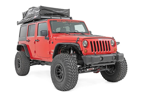 Red Jeep Wrangler JK 2007-2018 with front bumper caps for rock crawler stubby conversion, equipped with nylon caps.