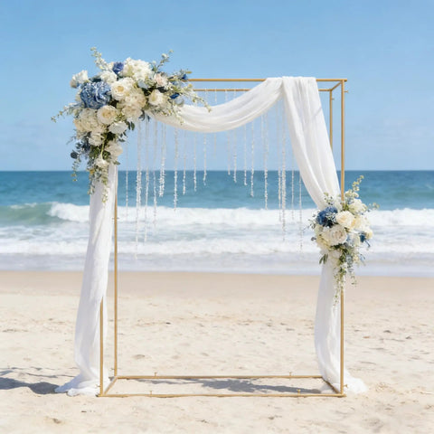 Gold Outdoor Metal Arbor Frame Stand 4.95 By 6.56 Ft Backyard Garden Arch Trellis For Plants And Wedding Backdrop Decor, Weatherproof Sturdy Arch With Black Coating For Wind Rain And Sun on a beach with draped floral decorations.
