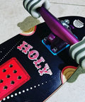 Close-up of skateboard with colorful design, featuring mounted white wheels. California Roll 60mm 78A White Skateboard Longboard Wheels visible.